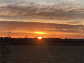 Scenic view of sunset over land