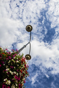 Low angle view of street light against cloudy sky