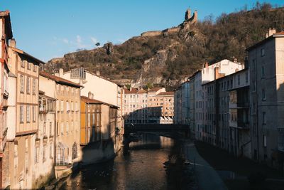 River amidst buildings against sky