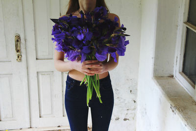 Woman holding purple flower