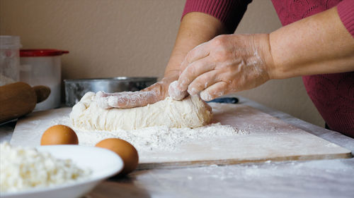 Midsection of person preparing food on table