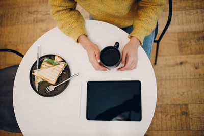 High angle view of man using laptop on table