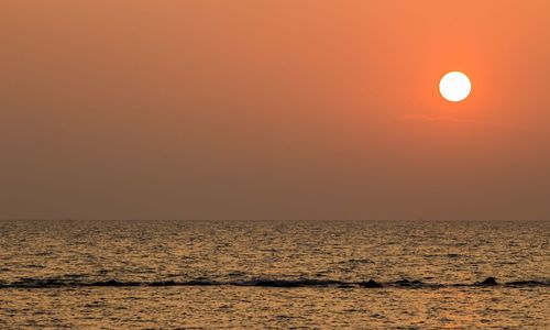 Scenic view of sea against clear sky during sunset