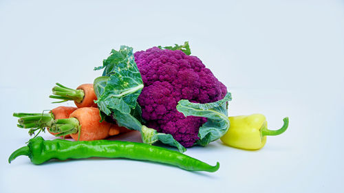 Close-up of chopped vegetables against white background