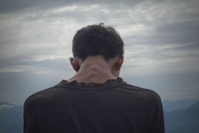 Rear view of man against sky