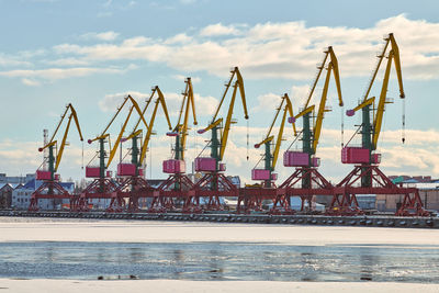 Massive harbor cranes in seaport. heavy load dockside cranes in port, cargo container yard, terminal