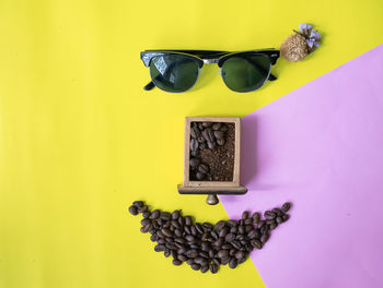 Close-up of sunglasses on table against wall