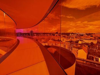 High angle view of modern buildings against sky during sunset