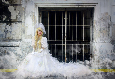 Portrait of woman against building