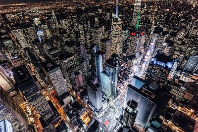 High angle view of city lit up at night