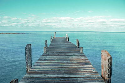 Pier over sea against sky