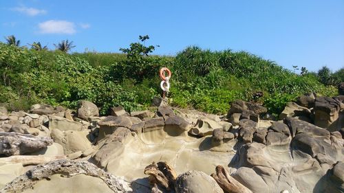 Statue on rock against sky