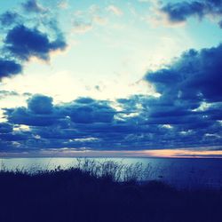 Scenic view of sea against cloudy sky