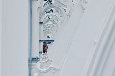 Woman amidst railing on bridge