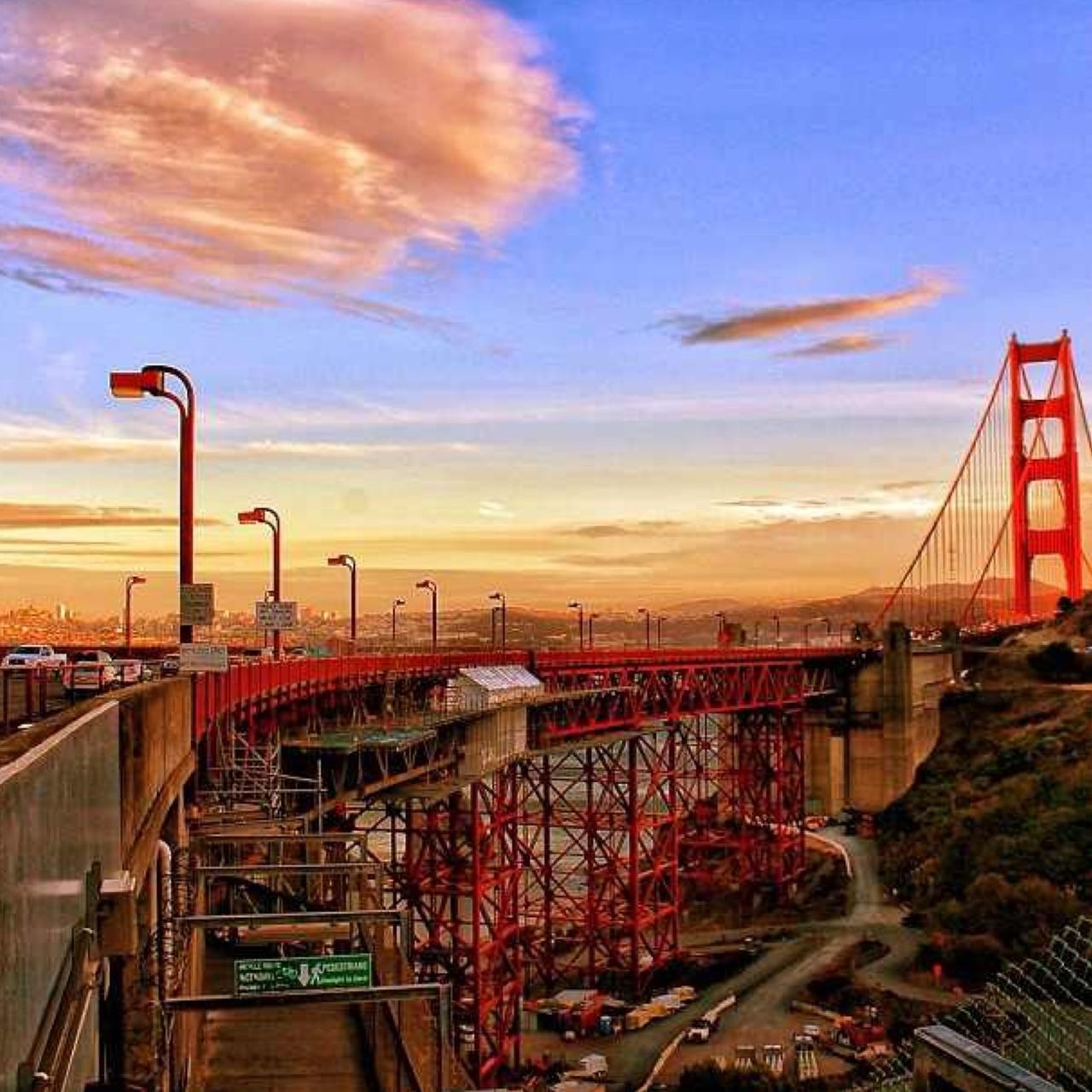 transportation, sky, street light, sunset, cloud - sky, railing, railroad track, built structure, architecture, mode of transport, rail transportation, land vehicle, bridge - man made structure, the way forward, city, connection, outdoors, cloud, road, car