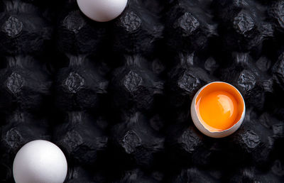 Overhead view of three eggs in a egg carton