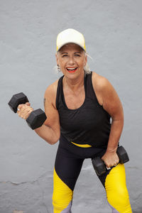 Portrait of fit senior woman with cool haircut wearing sports clothes