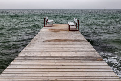 Pier over sea against clear sky