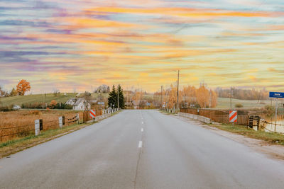 Empty road against cloudy sky