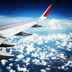 Airplane wing against blue sky