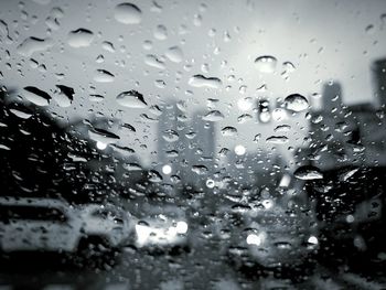 Full frame shot of wet glass window in rainy season