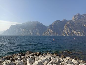 Scenic view of sea and mountains against sky