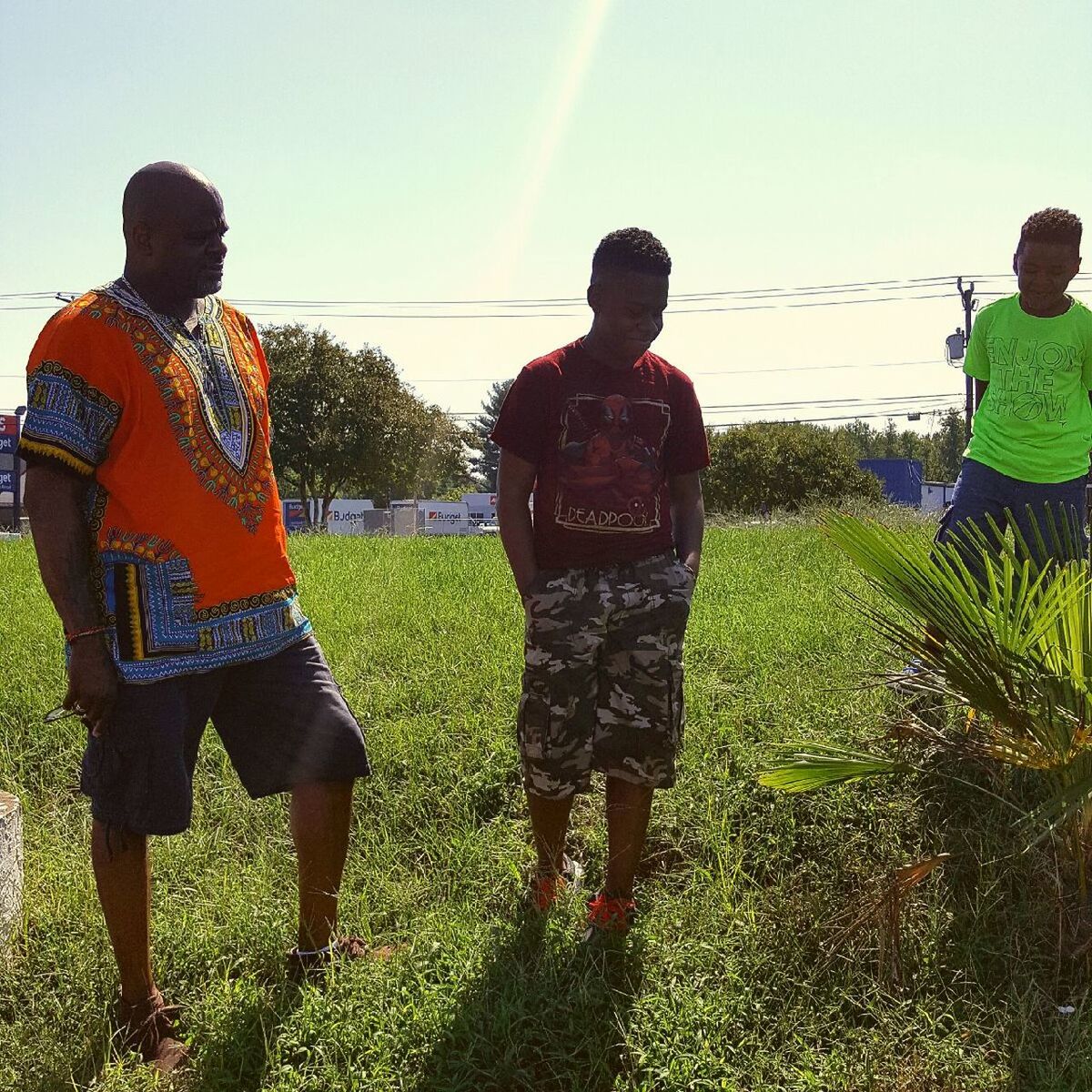 leisure activity, lifestyles, grass, field, shadow, sunlight, togetherness, casual clothing, rear view, childhood, sunbeam, full length, boys, playing, grassy, friendship, park - man made space, lens flare, day, green color, vacations, outdoors