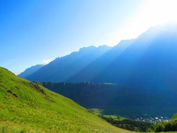 Scenic view of mountains against blue sky