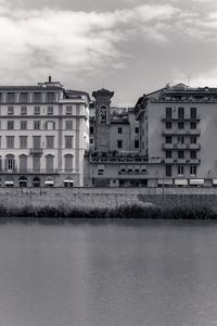 Buildings in city against cloudy sky