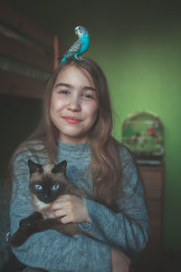 Portrait of smiling woman with cat