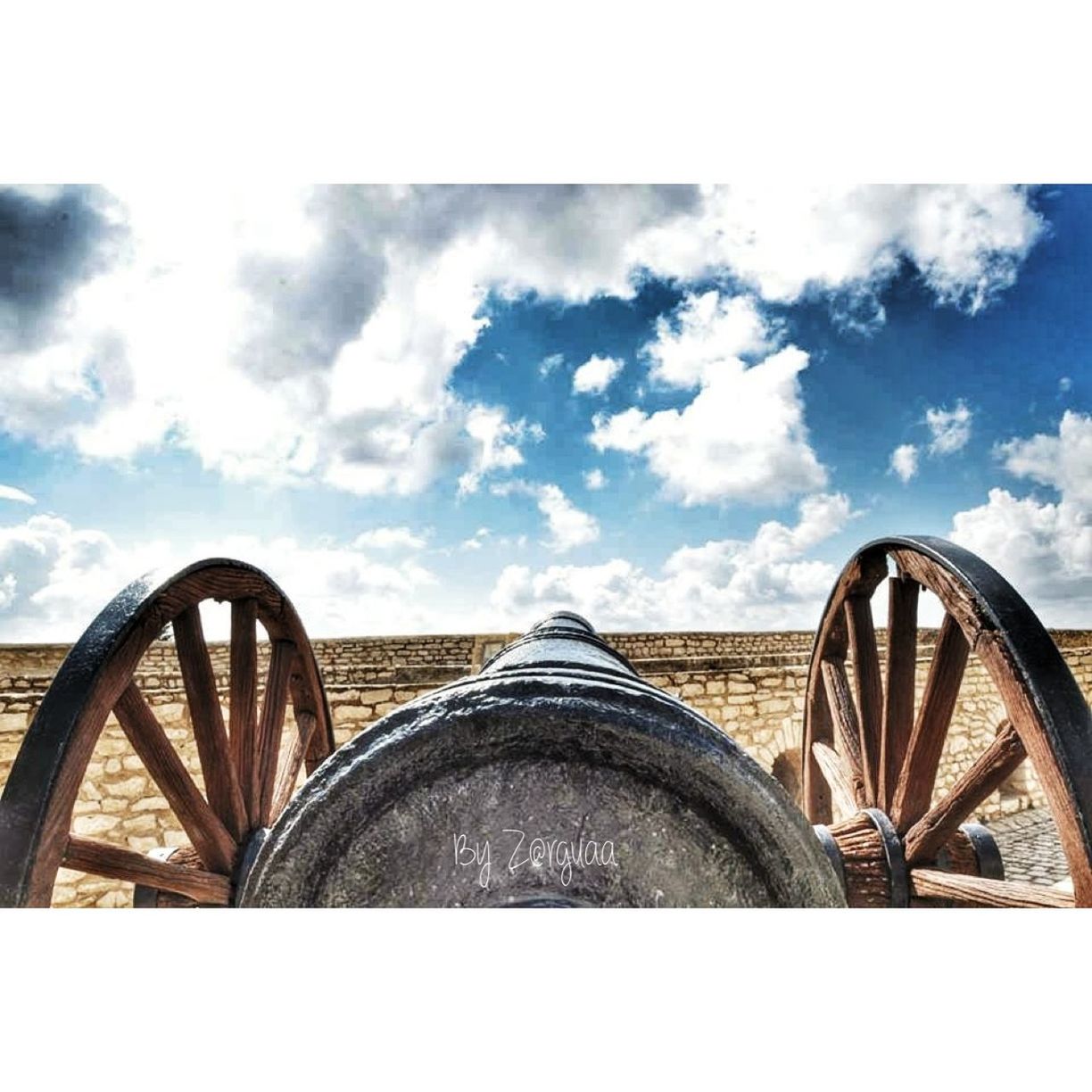 sky, cloud - sky, transportation, cloud, cloudy, wheel, mode of transport, built structure, architecture, land vehicle, outdoors, day, no people, low angle view, bicycle, part of, metal, stationary, old, circle