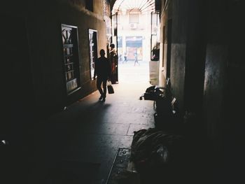 Rear view of people walking on building