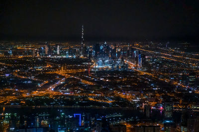 High angle view of city of dubai lit up at night
