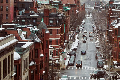 High angle view of street amidst buildings in city during winter