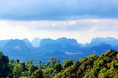 Scenic view of mountains against cloudy sky