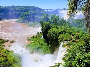 Scenic view of waterfall against sky