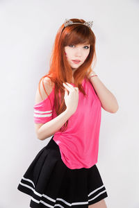 Portrait of woman standing against white background