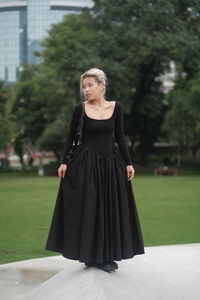 Portrait of young woman standing outdoors