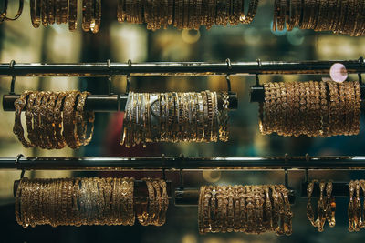 Close-up of bangles hanging on rack in shop