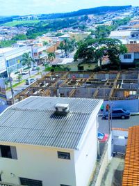 High angle view of swimming pool by buildings in city