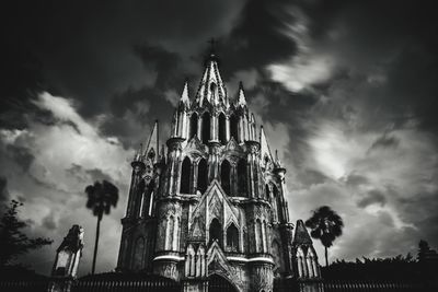 Low angle view of temple building against cloudy sky