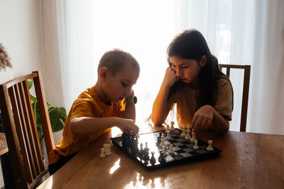 Siblings and woman at home