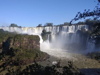 Scenic view of waterfall against clear sky