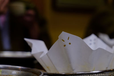 Close-up of paper in plate on table