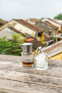 Close-up of drink on table against building