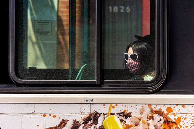 Portrait of man seen through train window