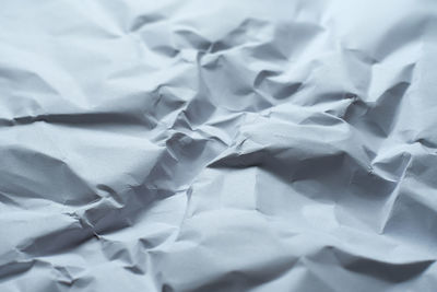 High angle view of white paper on bed