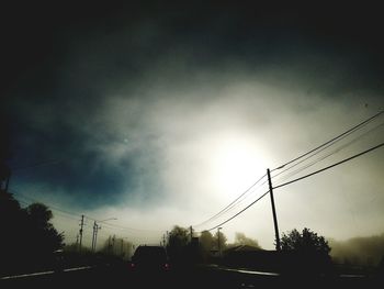 Low angle view of silhouette trees against sky