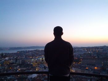 Man overlooking city at dusk