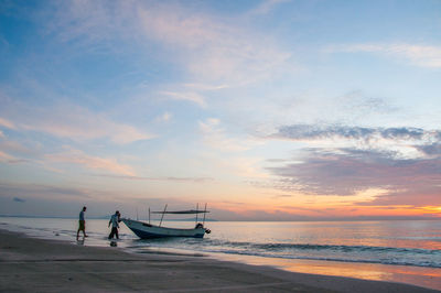 View of fishermen with boat at sea